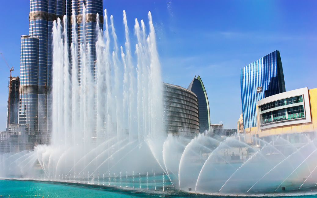 DUBAI, UAE - NOVEMBER 14: The Dancing fountains downtown and in a man-made lake in Dubai, UAE on November 14, 2012. The Dubai Dancing fountains are world's largest fountains with height 150 m. DUBAI, UAE - NOVEMBER 14: The Dancing fountains downtown and in a man-made lake in Dubai, UAE on November 14, 2012. The Dubai Dancing fountains are world's largest fountains with height 150 m. © Laborant / Shutterstock.com