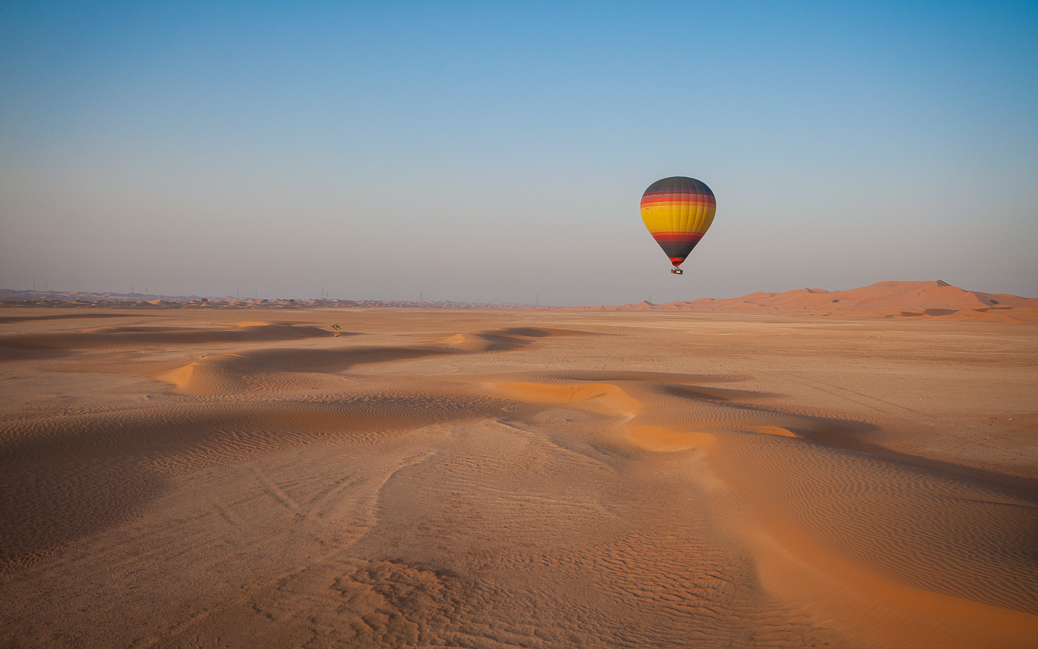 Hot Air Balloon floating over the desert sand Hot Air Balloon floating over the desert sand © Joseph Borg / Shutterstock.com